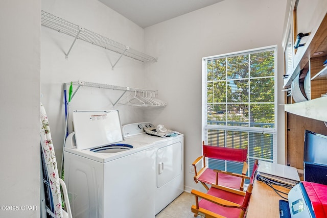 laundry room featuring light tile patterned flooring, laundry area, and washer and clothes dryer
