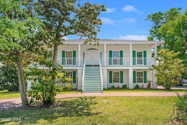 view of front of home with stairs, stucco siding, a porch, and a front lawn
