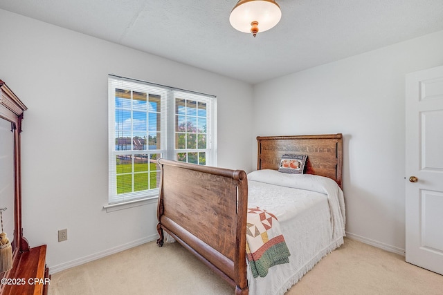 carpeted bedroom featuring baseboards