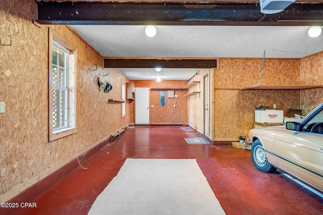 interior space with baseboards, a garage door opener, and electric panel
