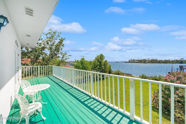 balcony with visible vents and a water view