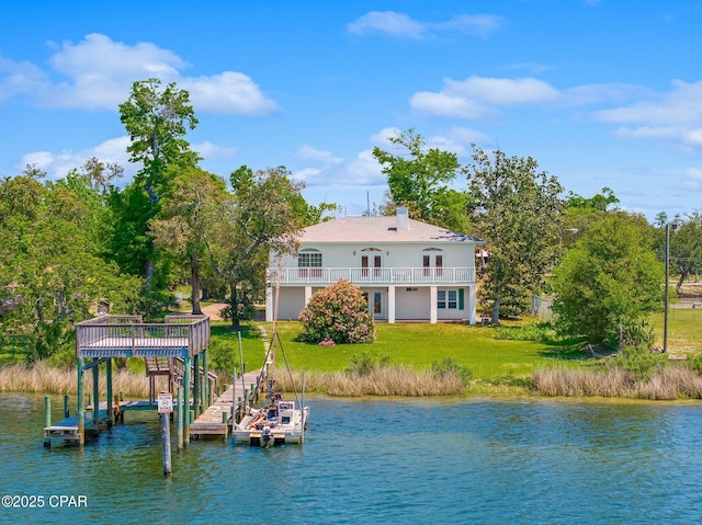 view of dock with a lawn, a water view, and boat lift