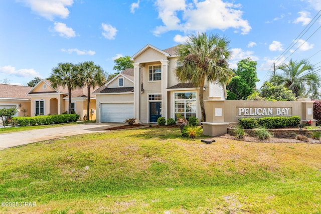 2501 Pelican Bay Dr, Panama City, FL 32408 - view of front of house with stucco siding, driveway, a garage, and a front yard