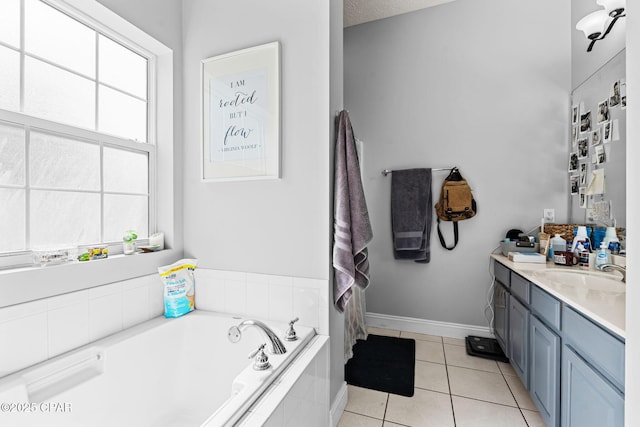 2501 Pelican Bay Dr, Panama City, FL 32408 - bathroom with tile patterned flooring, vanity, a garden tub, and baseboards
