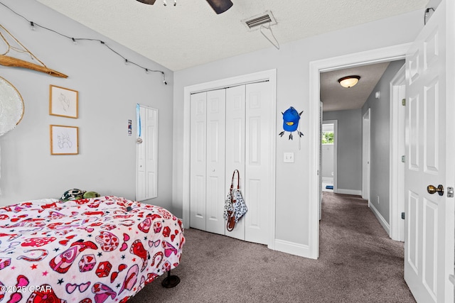 2501 Pelican Bay Dr, Panama City, FL 32408 - carpeted bedroom with a textured ceiling, a closet, baseboards, and a ceiling fan