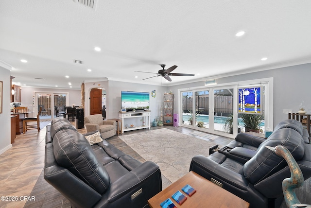 living area featuring visible vents, recessed lighting, and crown molding
