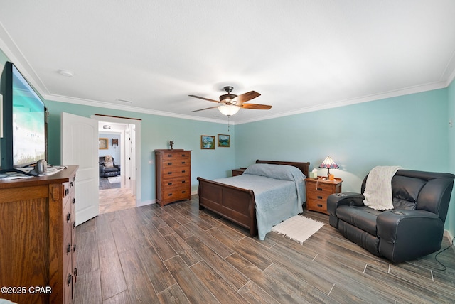 bedroom featuring dark wood finished floors, baseboards, ornamental molding, and a ceiling fan