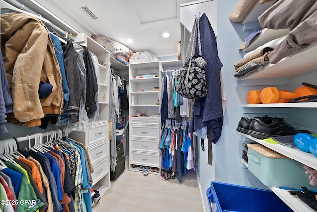walk in closet with attic access and visible vents