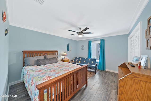 bedroom with visible vents, baseboards, a ceiling fan, wood finished floors, and ornamental molding