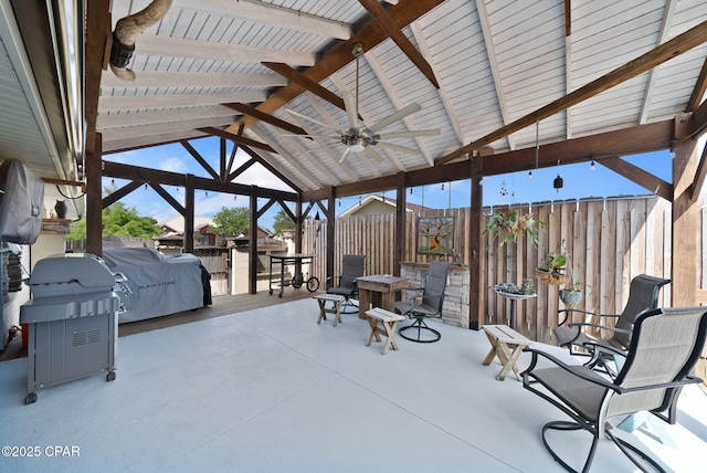 view of patio with fence, a ceiling fan, and a gazebo