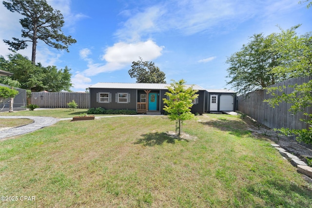 mid-century modern home with metal roof, a front yard, and a fenced backyard