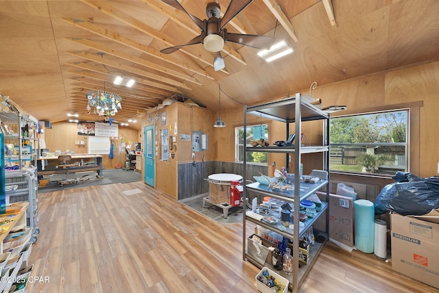misc room featuring ceiling fan, wood-type flooring, and vaulted ceiling