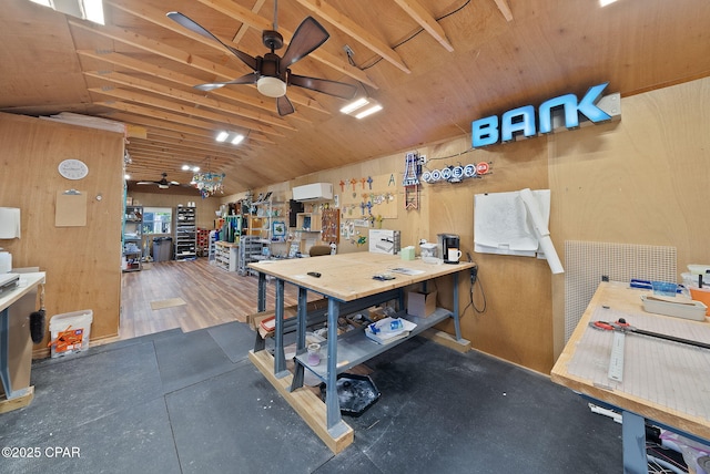misc room featuring lofted ceiling, a workshop area, an AC wall unit, and a ceiling fan