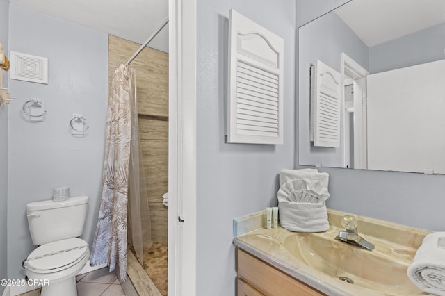 bathroom with vanity, tile patterned flooring, a shower stall, and toilet