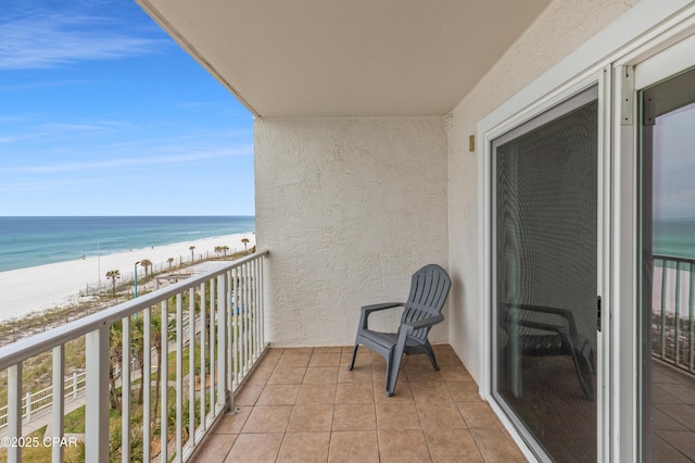 balcony with a water view and a beach view