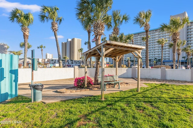 view of property's community featuring a yard, a gazebo, and fence