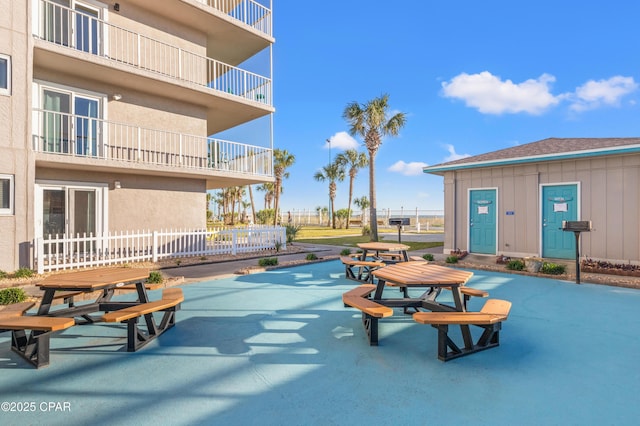 view of community featuring a patio and fence