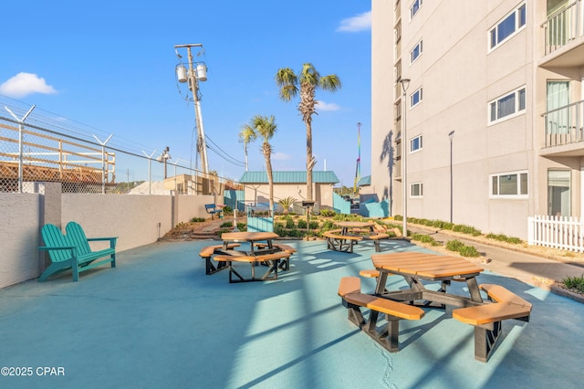 view of home's community featuring fence and a patio