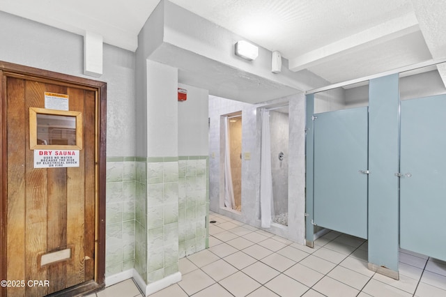bathroom with tile patterned floors and a shower stall