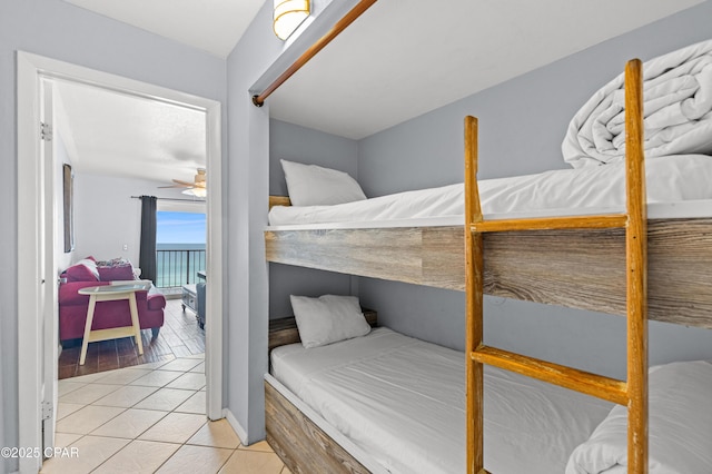 bedroom with access to outside and light tile patterned floors