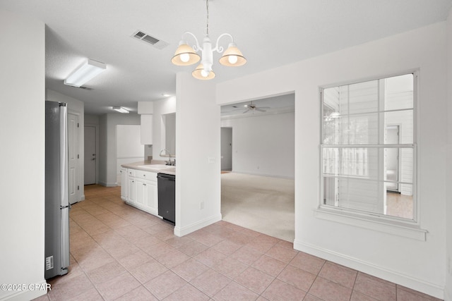 kitchen featuring a sink, visible vents, white cabinetry, light countertops, and ceiling fan with notable chandelier
