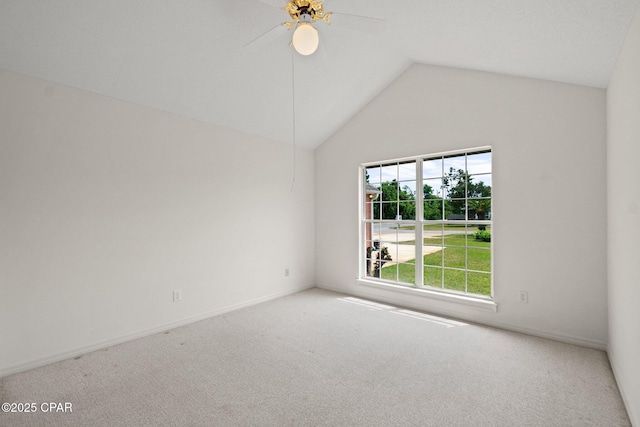 carpeted spare room featuring baseboards, a ceiling fan, and lofted ceiling