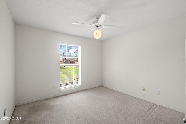 unfurnished room with ceiling fan, baseboards, and carpet floors