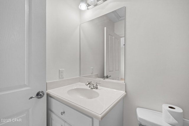 half bathroom featuring toilet and vanity