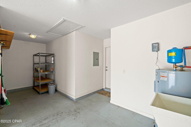 garage featuring electric panel and baseboards