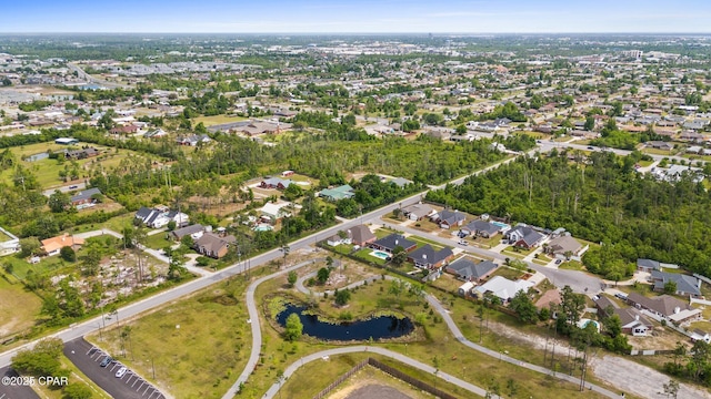 drone / aerial view with a residential view and a water view