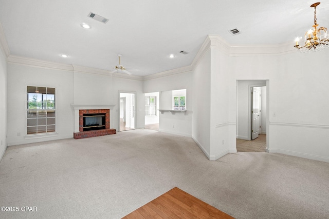 unfurnished living room with crown molding, visible vents, light carpet, and baseboards