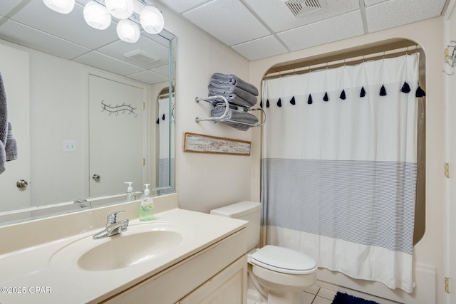 full bath featuring visible vents, toilet, vanity, and a paneled ceiling