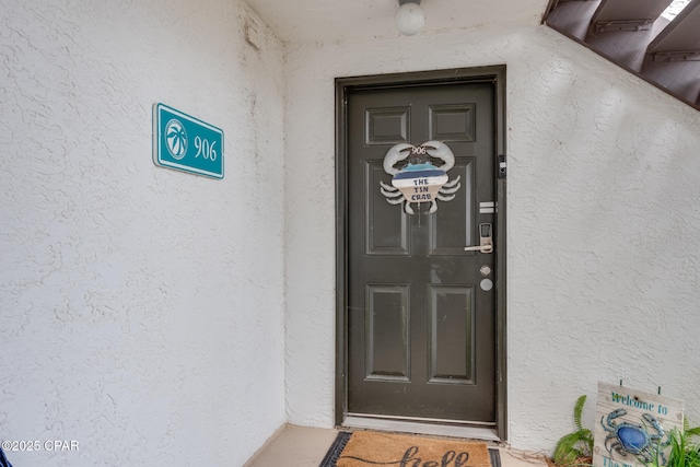 entrance to property with stucco siding
