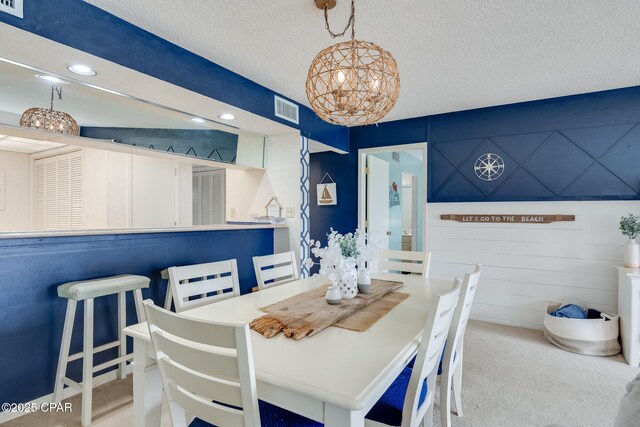 dining room featuring carpet, visible vents, recessed lighting, and a textured ceiling
