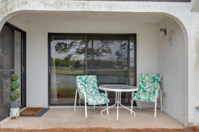 entrance to property featuring stucco siding