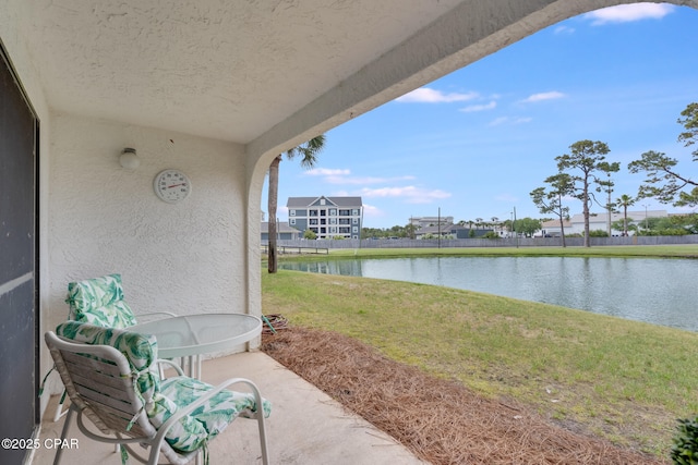 view of patio with a water view