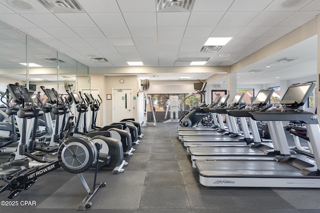 gym featuring visible vents and a paneled ceiling