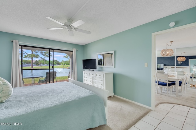 bedroom featuring a textured ceiling, carpet flooring, access to exterior, baseboards, and ceiling fan with notable chandelier