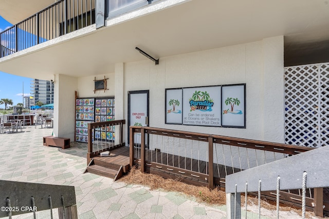 entrance to property featuring stucco siding