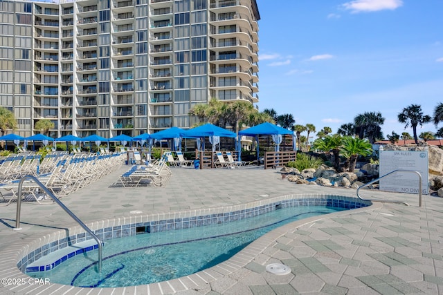 view of pool with a pool, a patio, and a community hot tub