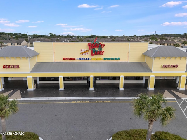 view of building exterior featuring uncovered parking