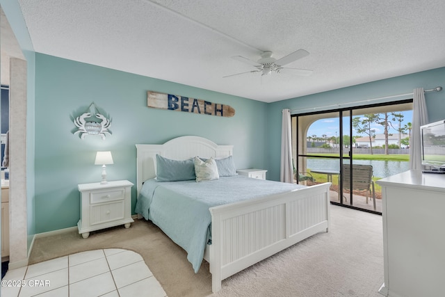 bedroom featuring a textured ceiling, ceiling fan, access to outside, and light carpet