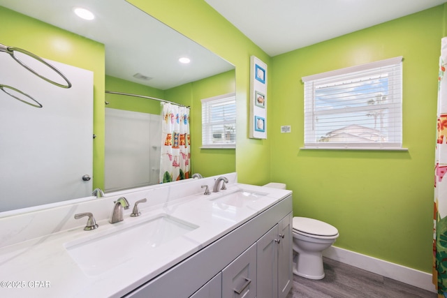 full bathroom featuring a sink, baseboards, toilet, and wood finished floors