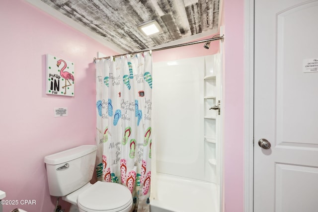 bathroom featuring toilet and a shower with shower curtain