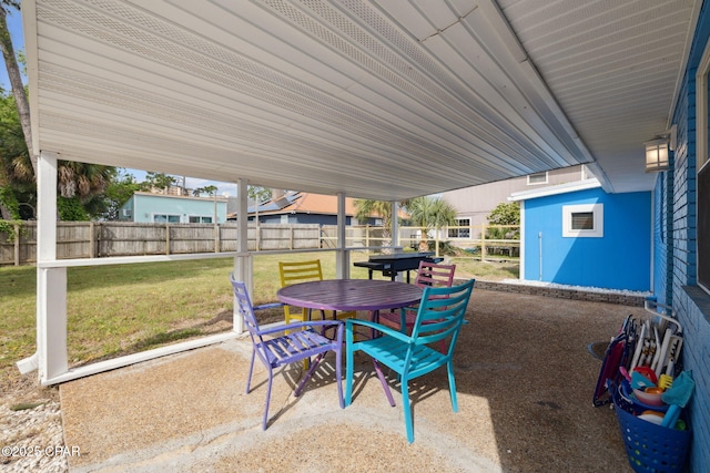 view of patio with a fenced backyard and outdoor dining area