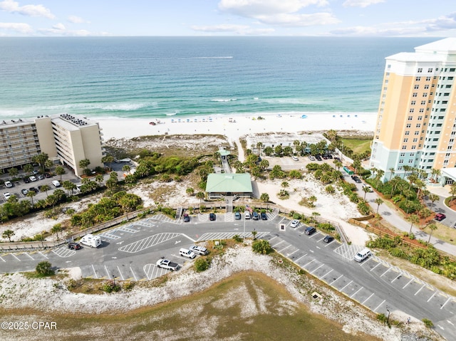 birds eye view of property with a water view and a view of the beach