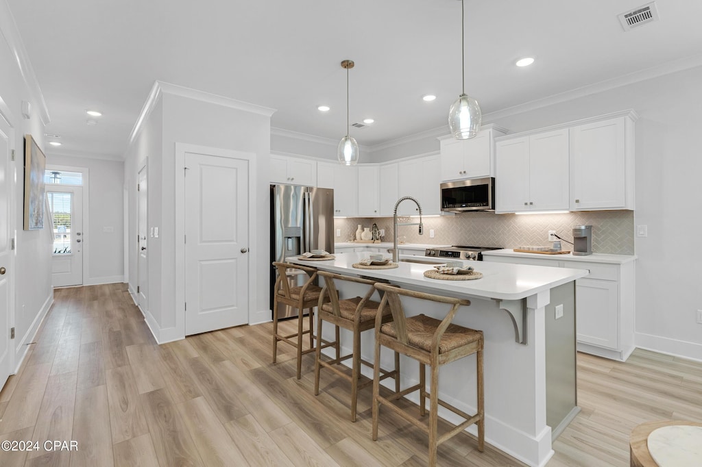 235 Skylah Ln Unit 18, Panama City Beach, FL 32407 - kitchen with appliances with stainless steel finishes, light countertops, crown molding, light wood-style floors, and backsplash