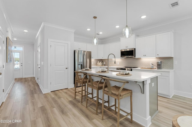 235 Skylah Ln Unit 18, Panama City Beach, FL 32407 - kitchen with appliances with stainless steel finishes, light countertops, crown molding, light wood-style floors, and backsplash