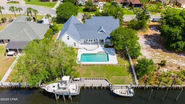 drone / aerial view with a water view and a residential view