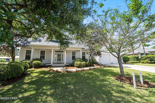 view of front of home with driveway, a front lawn, and an attached garage